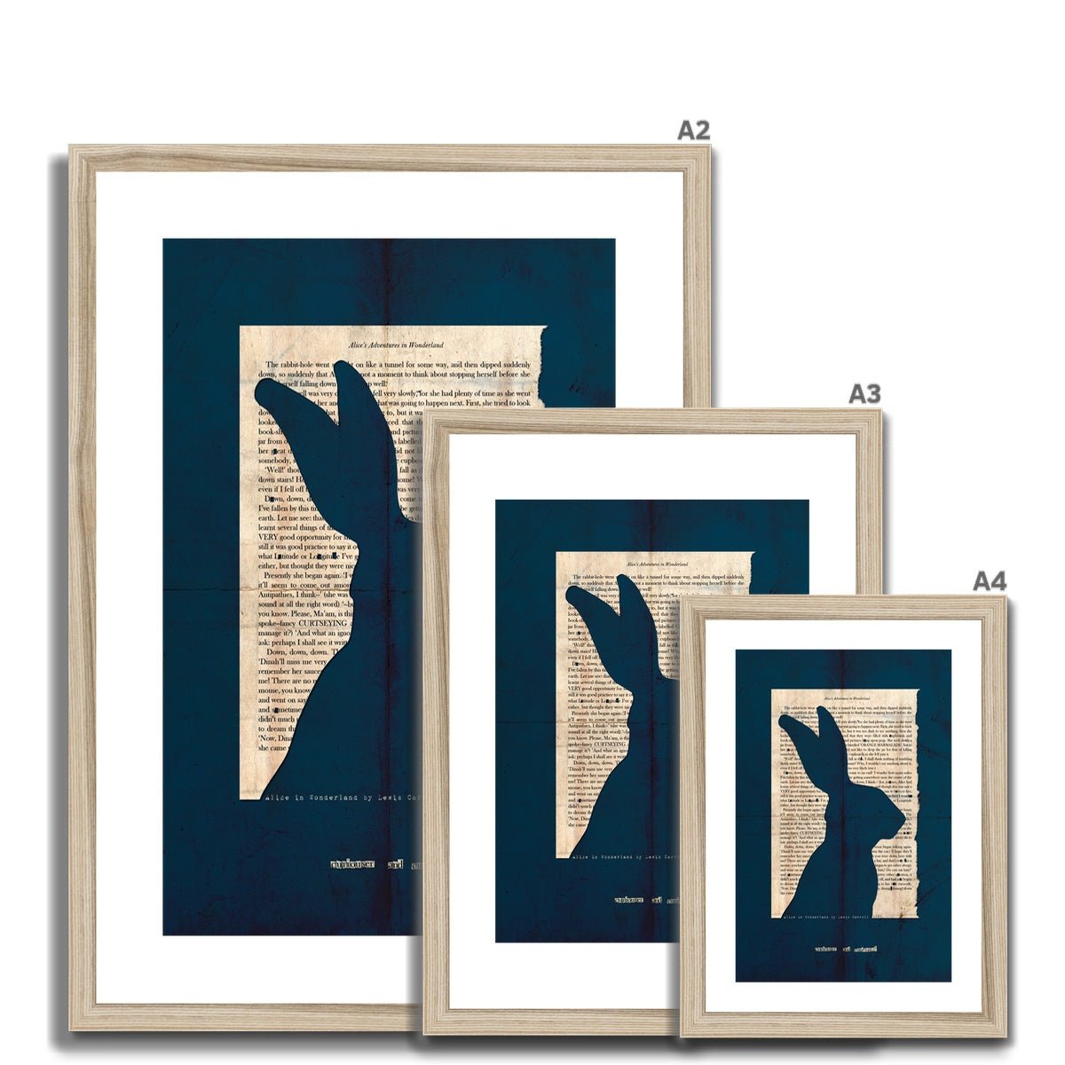 A collection of natural wooden framed fine art prints ranging from A2 to A4 depicting a page from Alice in Wonderland with the silhouette of a Hare cut out on a navy blue background with the line "curiouser and curiouser" also cut out